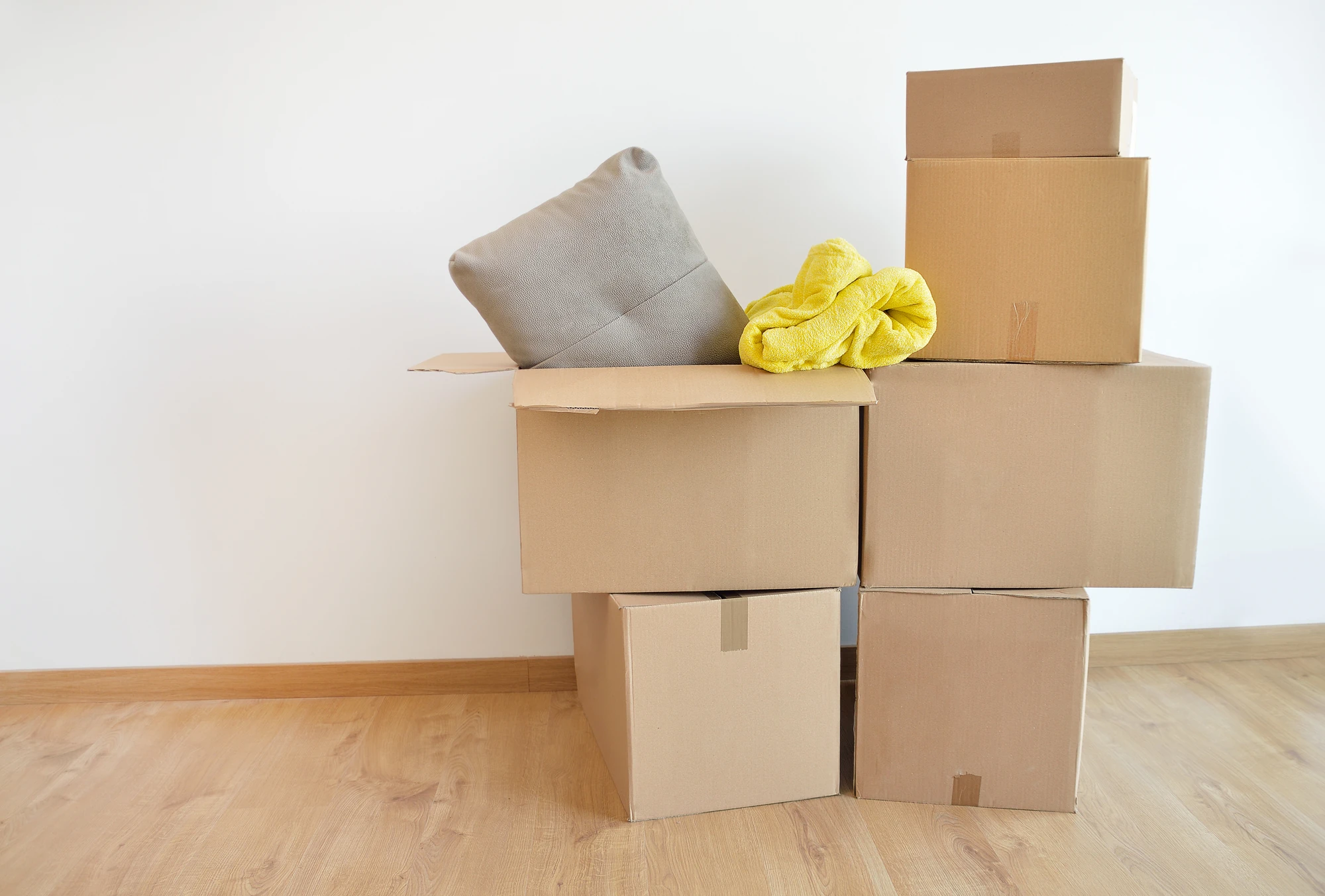 boxes piled with moving blanket on top