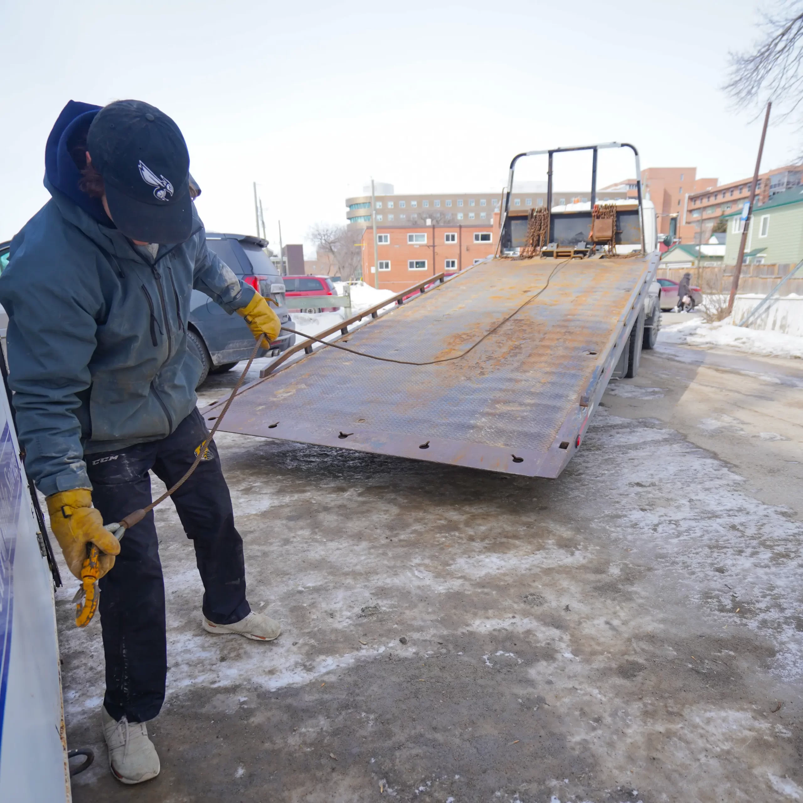 person hooking up container to truck